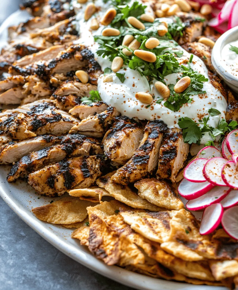 Chicken Shawarma Fatteh is a vibrant and delicious Middle Eastern dish that beautifully marries the essence of traditional shawarma with the comforting layers of a fatteh. This dish is characterized by tender, marinated chicken served over a bed of crispy pita bread, drenched in a rich, creamy yogurt-tahini sauce, and topped with a medley of fresh ingredients. The combination of textures and flavors in Chicken Shawarma Fatteh makes it a favorite among food enthusiasts and is sure to impress at any gathering.